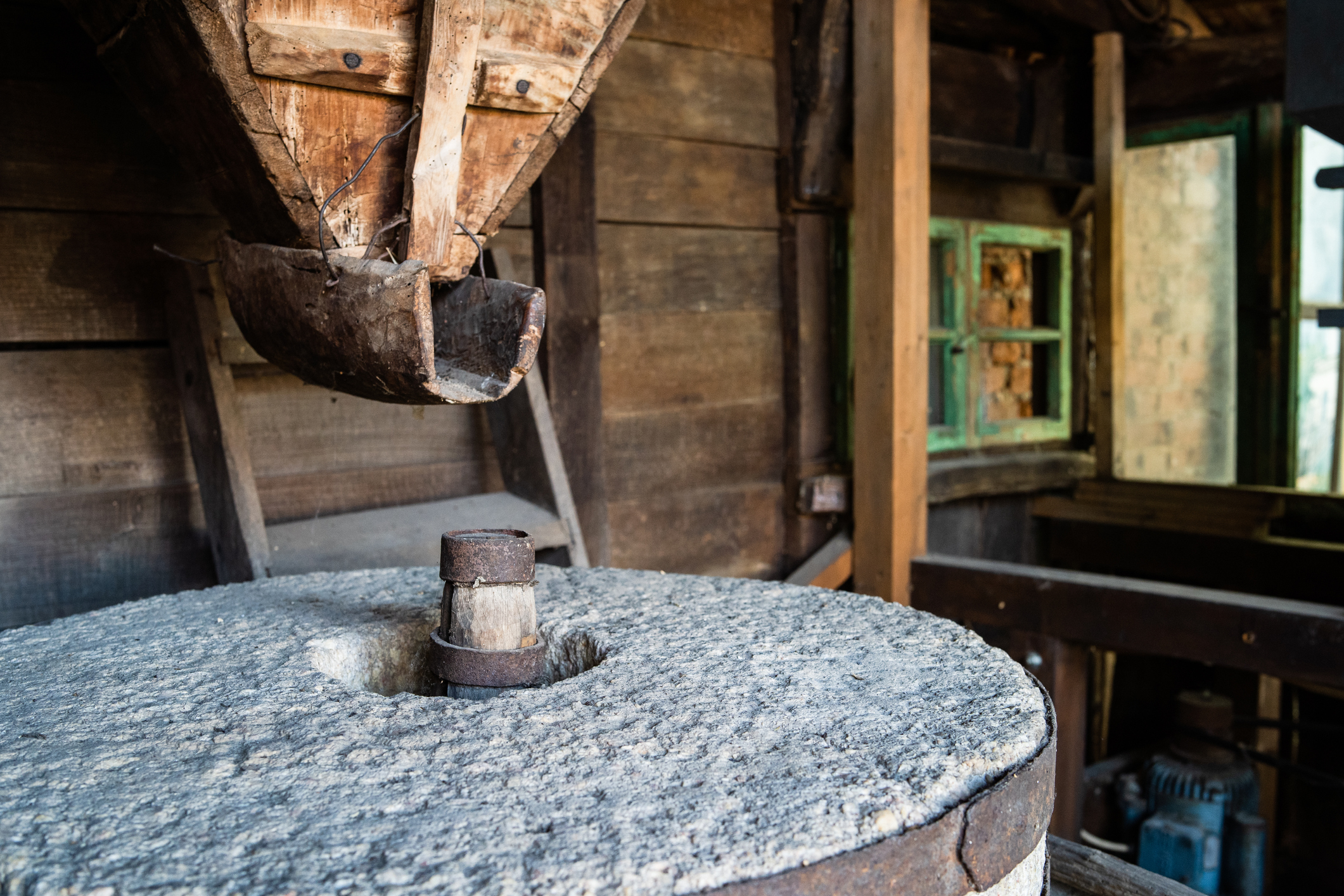 An ancient old stone grain mill gristmill grinding wheat or grains into flour using millstone. 